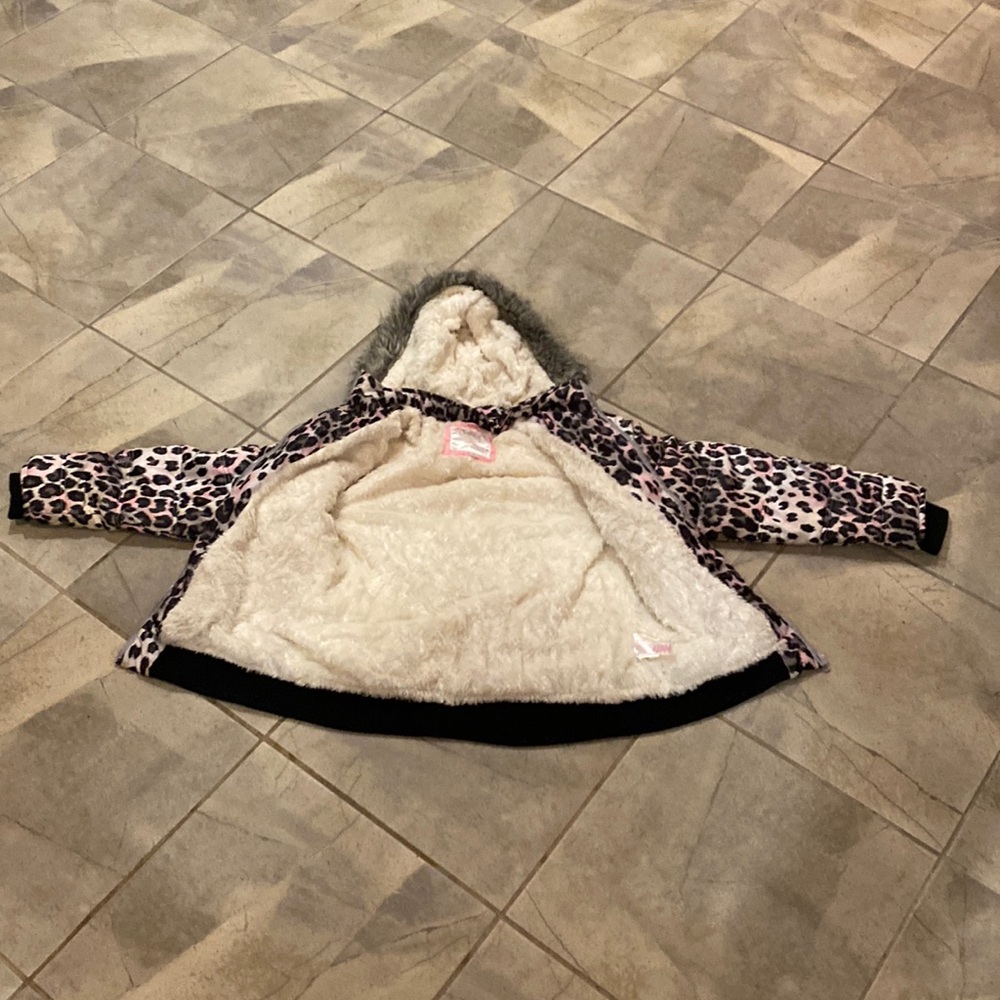 A winter jacket Cheetah print with black brown gray and pink on it
